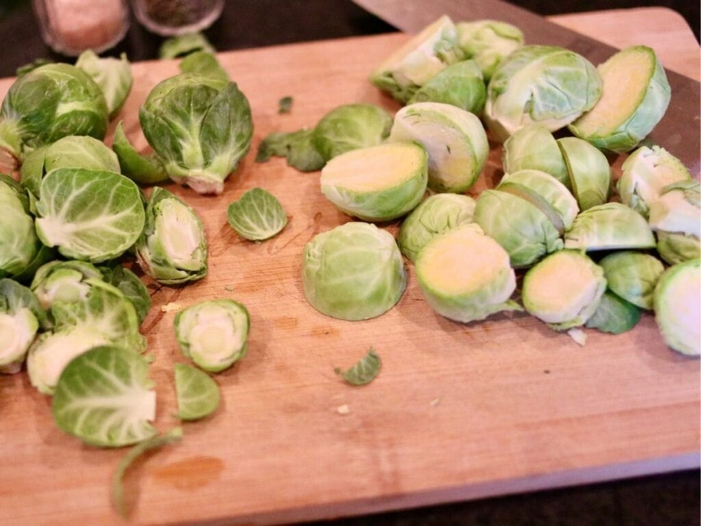 Halving Brussels sprouts on a cutting board