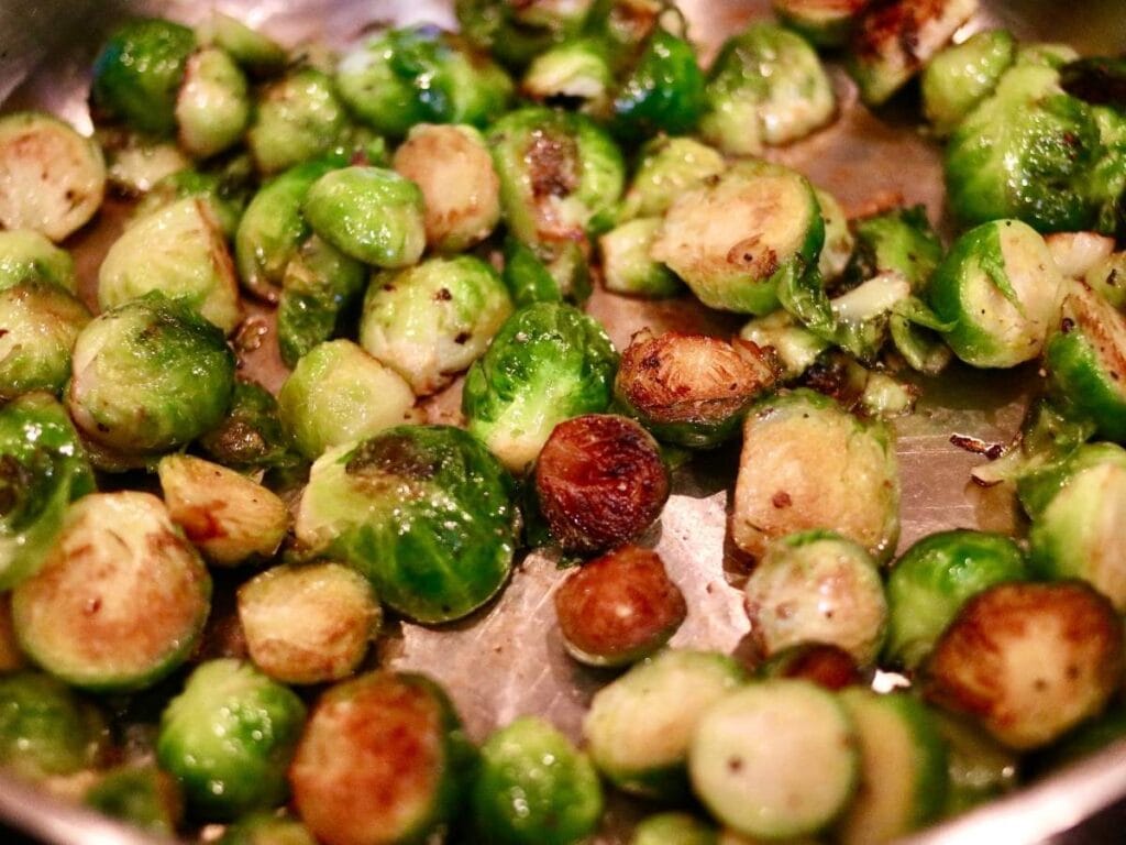 closeup of cooked Brussels sprouts in a skillet