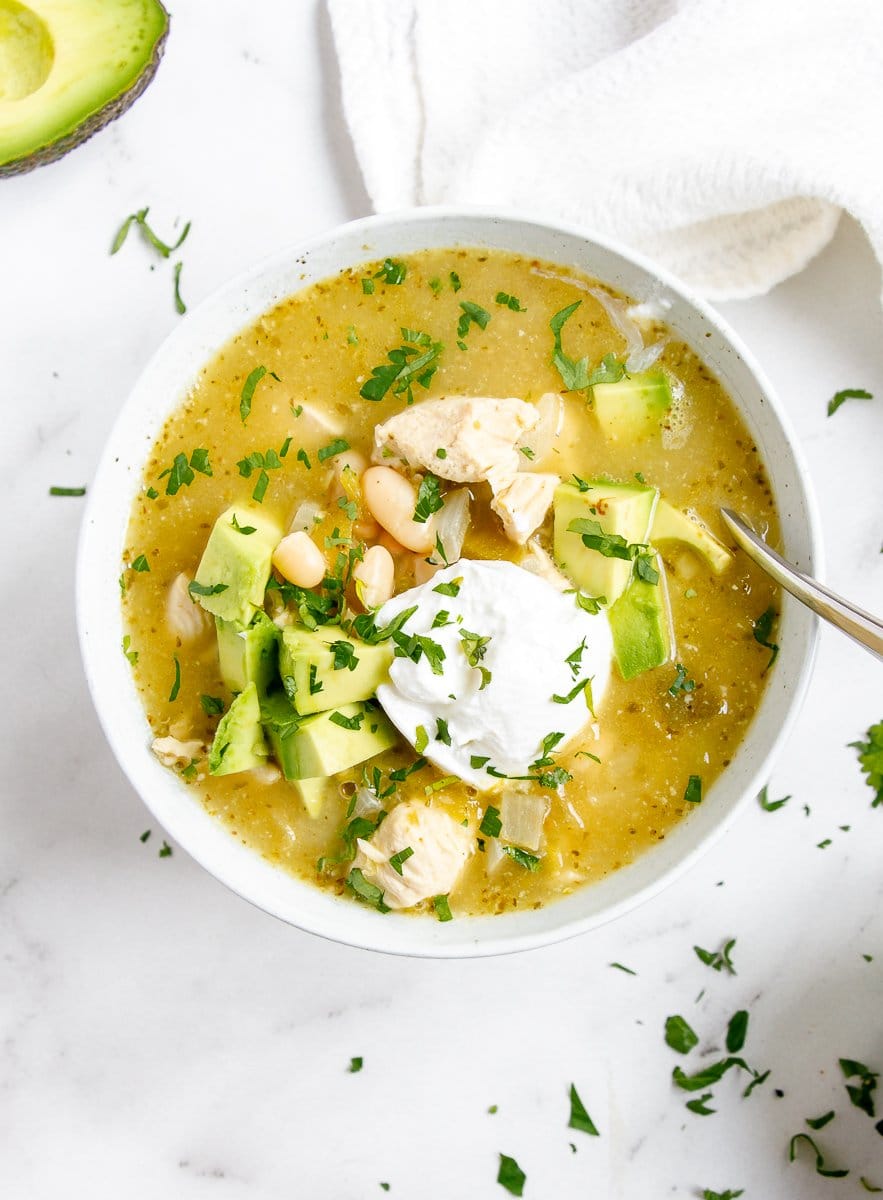 chicken chili with sour cream and avocado in a bowl