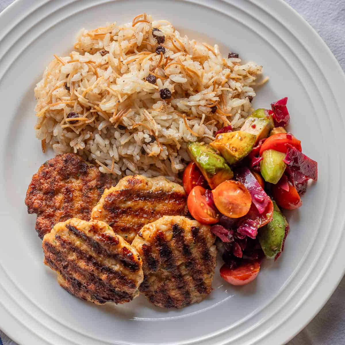 chicken kofta, rice, and vegetables on a plate