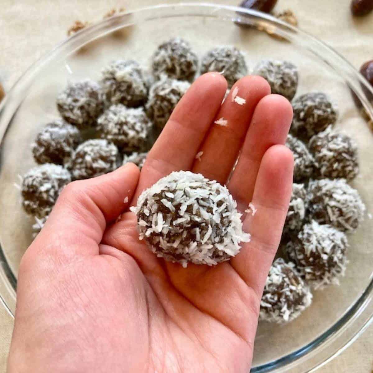 Closeup of hand holding energy ball with dates.