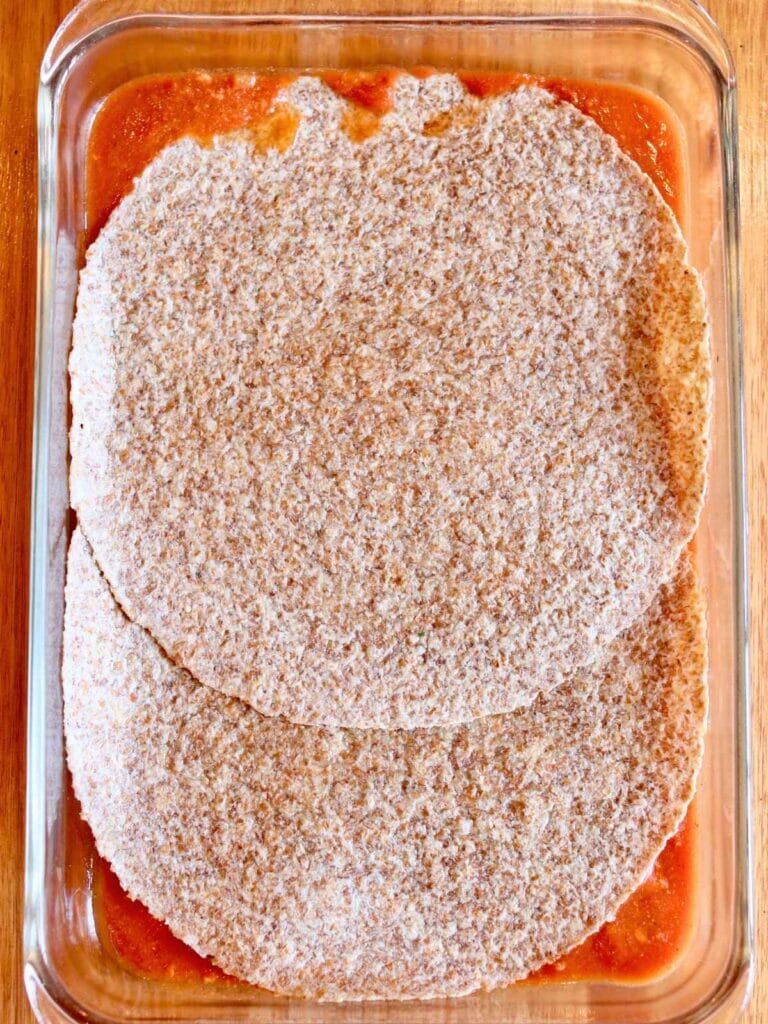 Tortilla layer in a baking dish.
