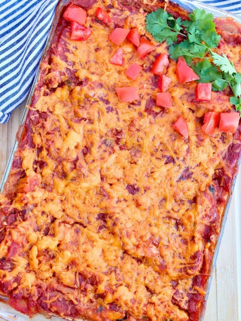 Chicken enchilada casserole in a baking dish.