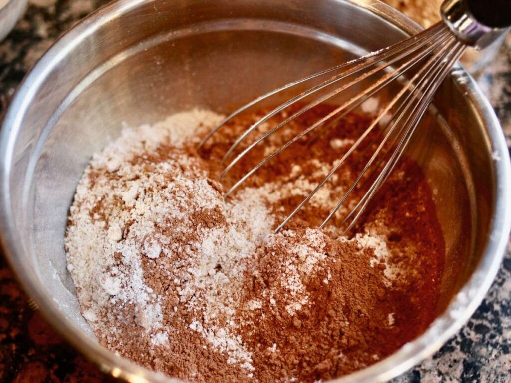 Whisking dry cupcake ingredients together.