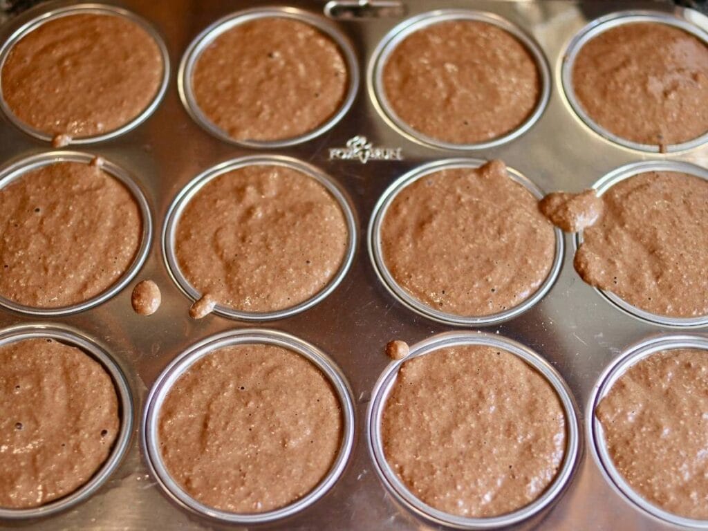Chocolate cupcake batter in muffin pan.