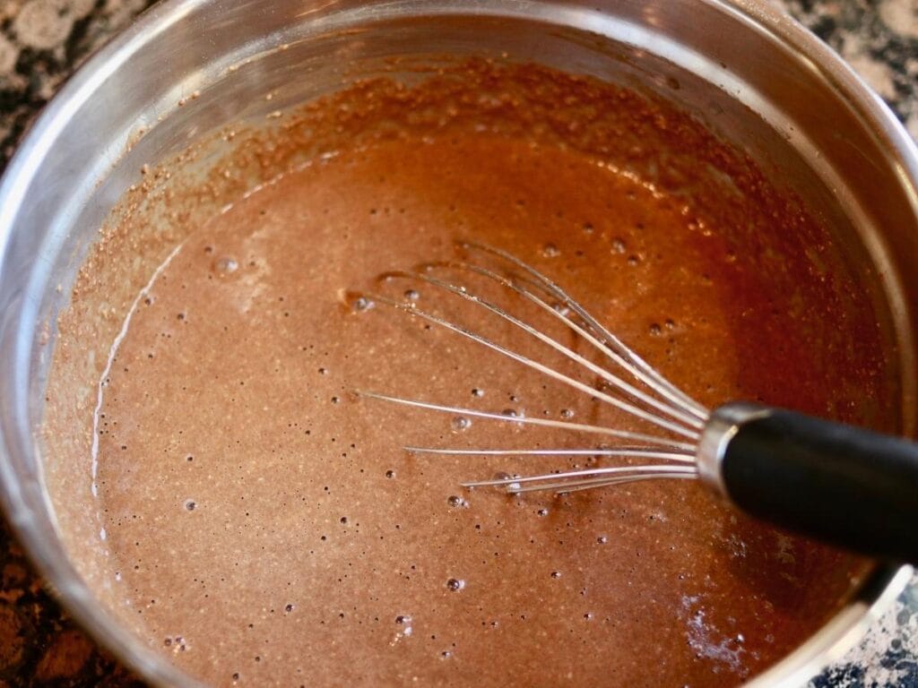 Whisking chocolate cupcake batter.