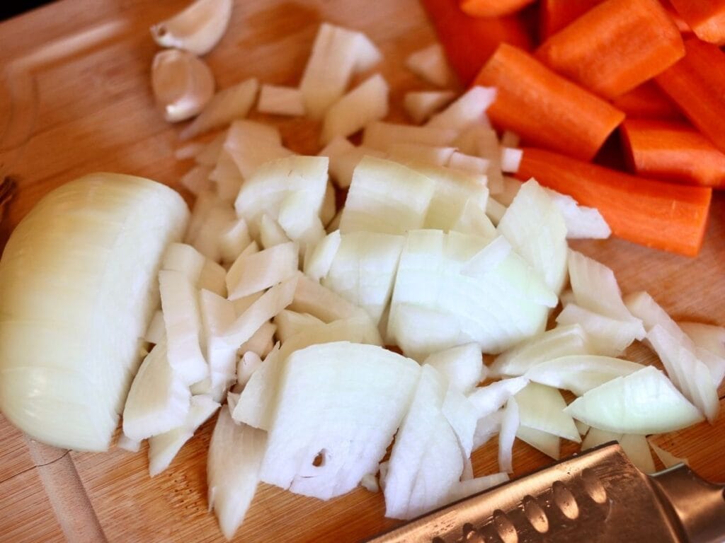 Chopping an onion and carrots.