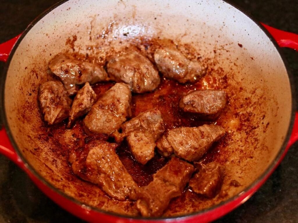 Searing stew meat in a Dutch oven.
