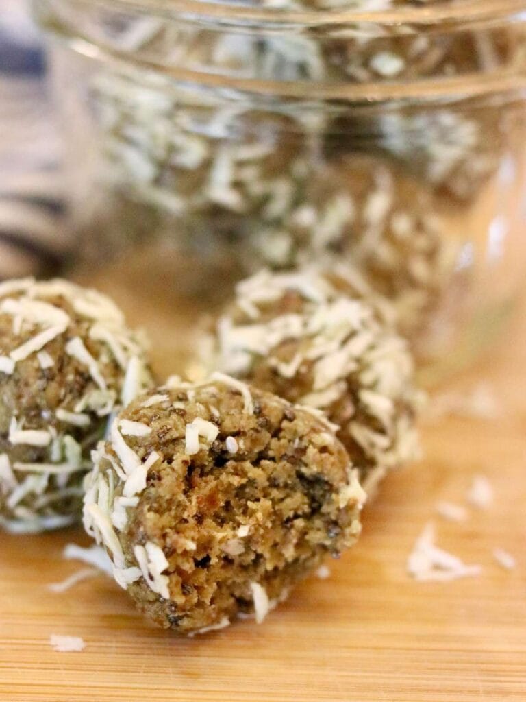 Oat-free protein ball with dates with a bite taken out.