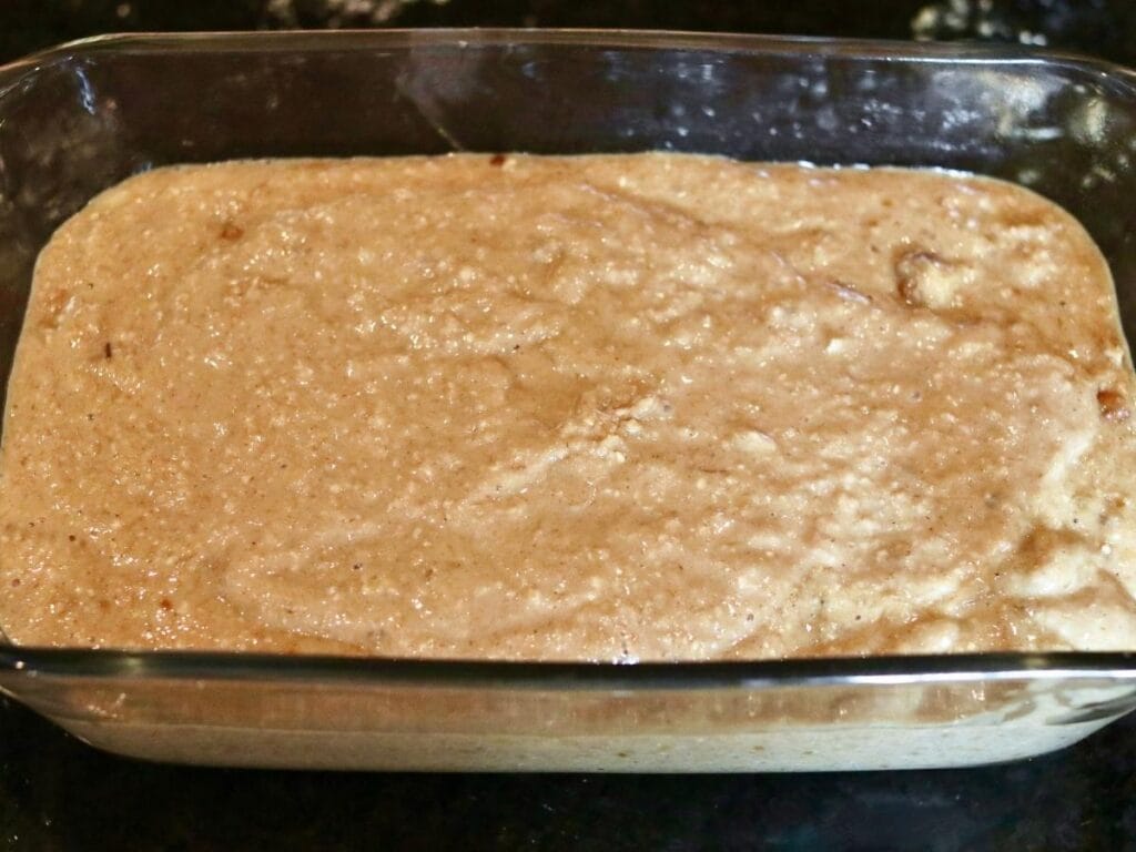 Batter in a glass bread pan.