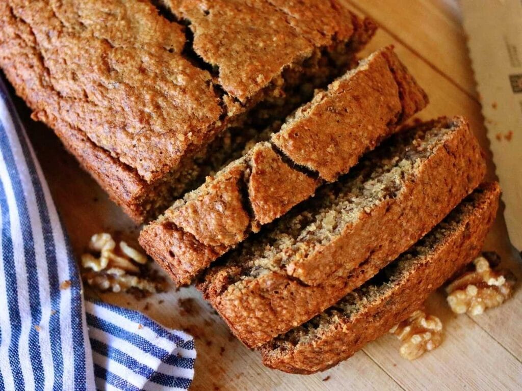 A loaf of oat flour banana bread with a few slices cut off.