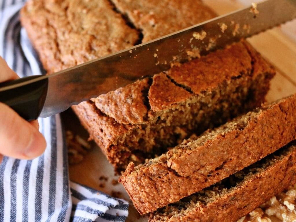 Slicing oat flour banana bread.