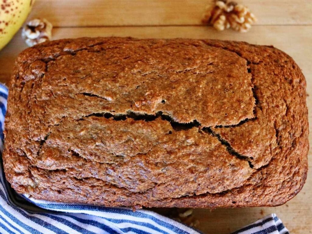 Loaf of oat flour banana bread on a cutting board.