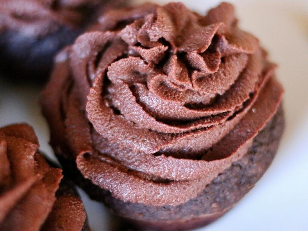 Closeup of chocolate frosting on a chocolate cupcake.