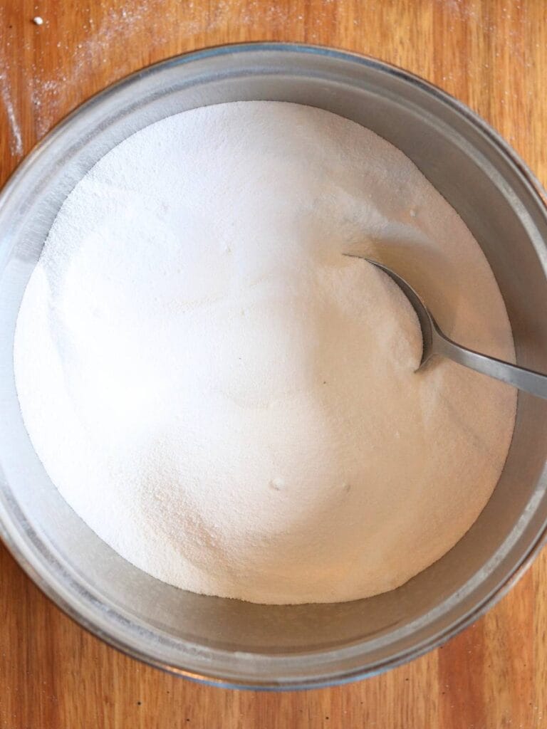 Stirring ingredients for detergent in a bowl.