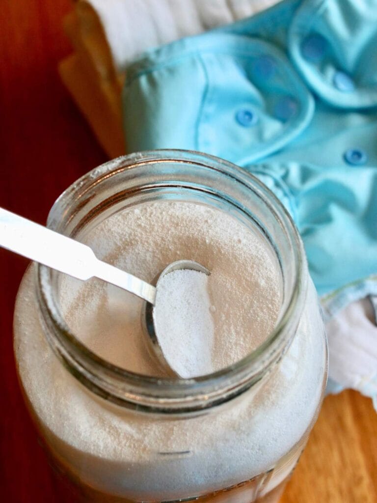 Spoon in a jar of cloth diaper detergent.