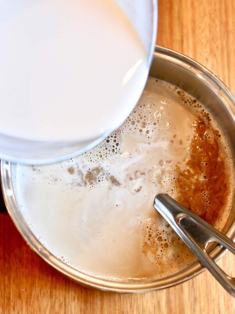 Pouring cream into ice cream mixture.