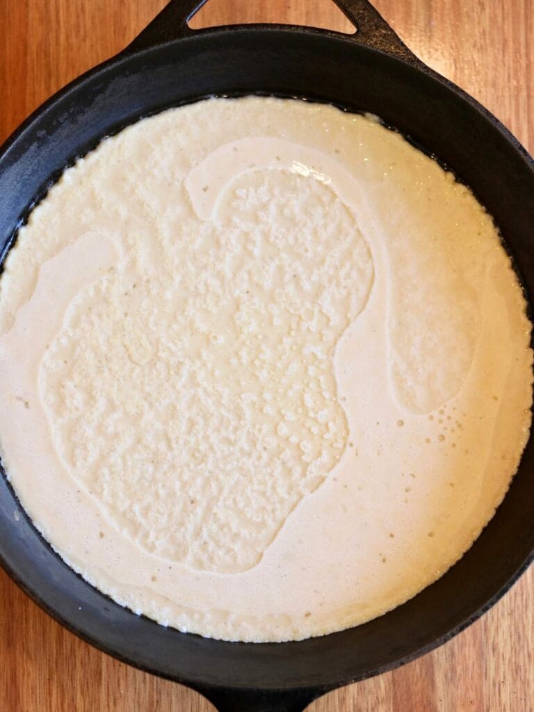 Batter in a cast iron skillet.