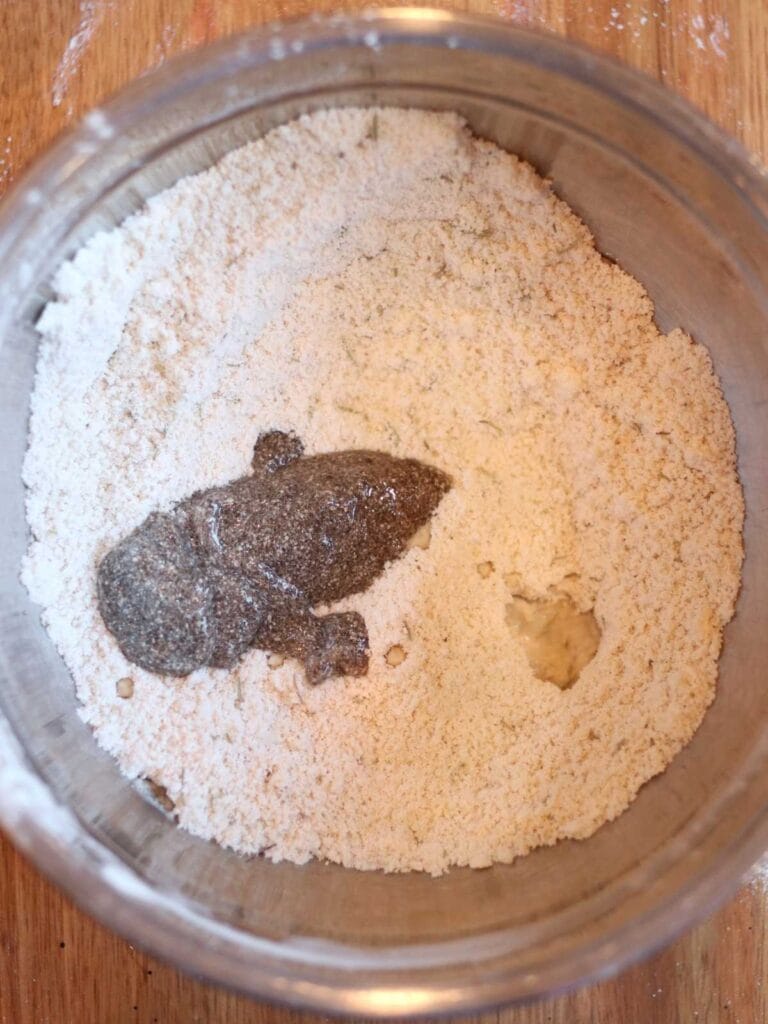 Chia seed egg and water in a bowl with dry ingredients.