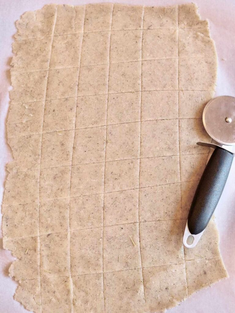Dough cut into squares with pizza cutter.