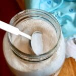 Closeup of spoon in a jar of cloth diaper detergent.