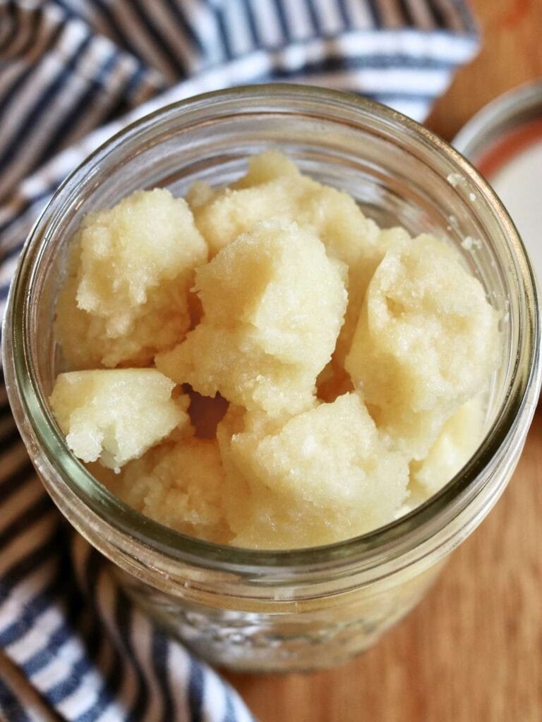 Mason jar with garlic paste portions in it.