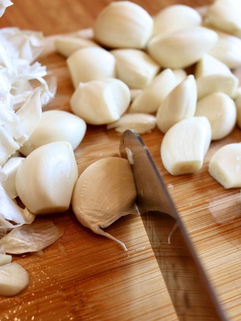 Chopping the end off of a garlic clove.