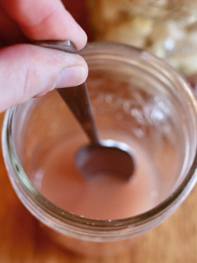 Dissolving salt in a jar of water.