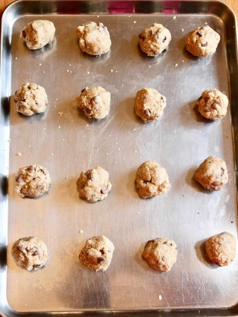 Balls of cookie dough on a baking sheet.