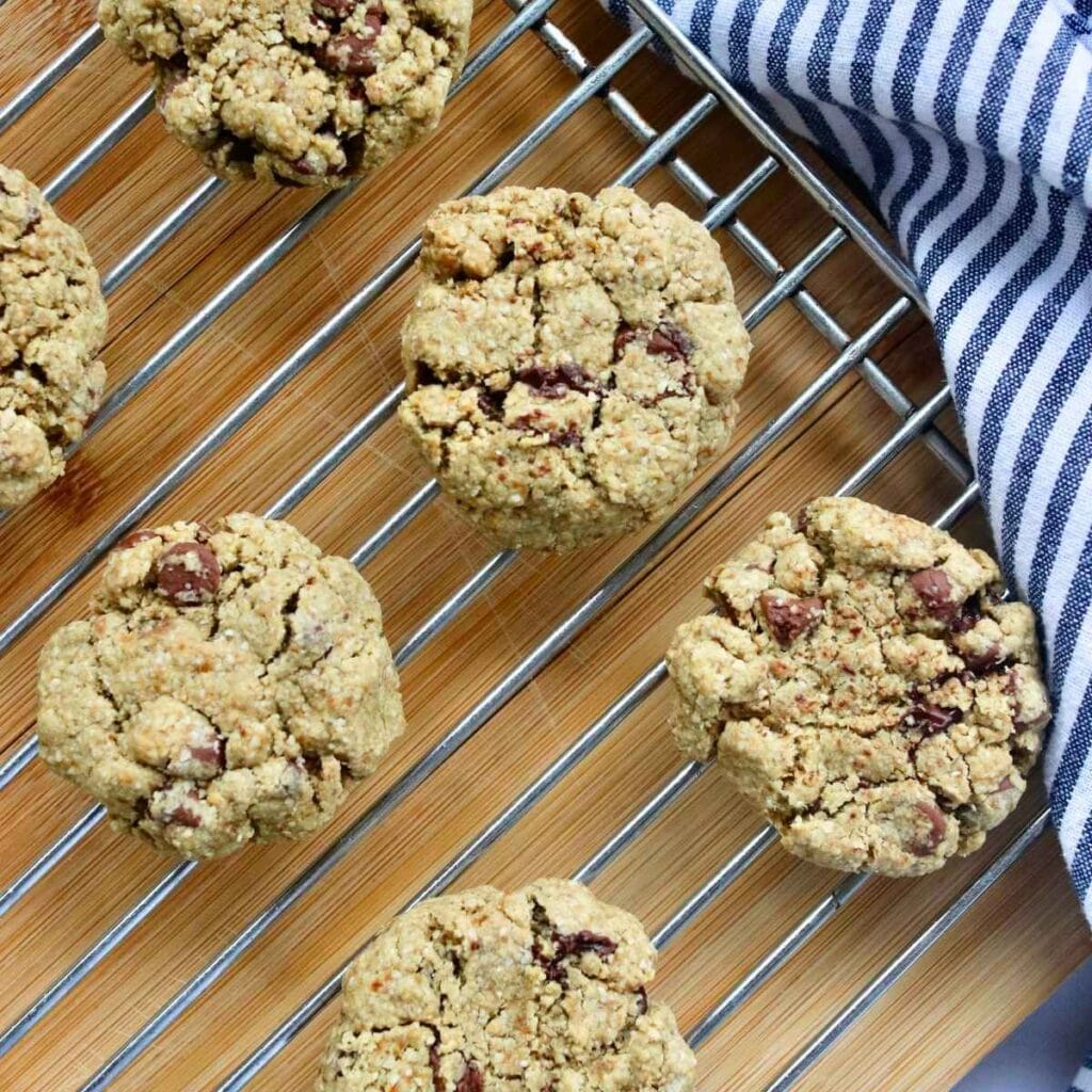 Closeup view of oat flour chocolate chip cookies on a cooling rack.
