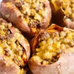 Closeup of sweet potato and ground beef covered with cheese.