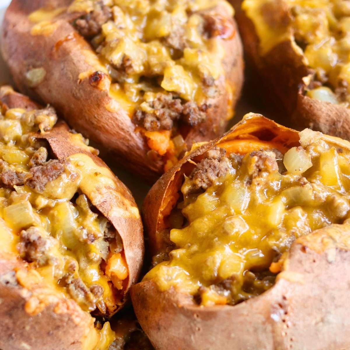 Closeup of sweet potato and ground beef covered with cheese.