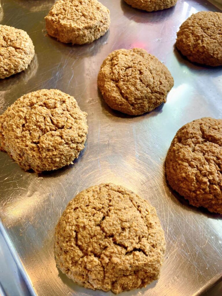 Gluten-free pumpkin cookies just out of the oven still on a baking sheet.