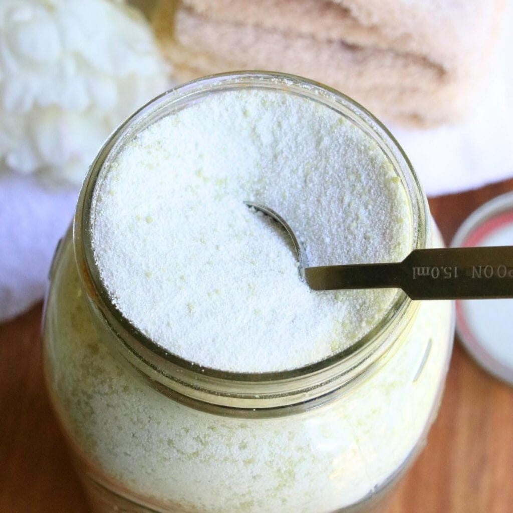 Tablespoon in a glass jar full of homemade laundry powder.