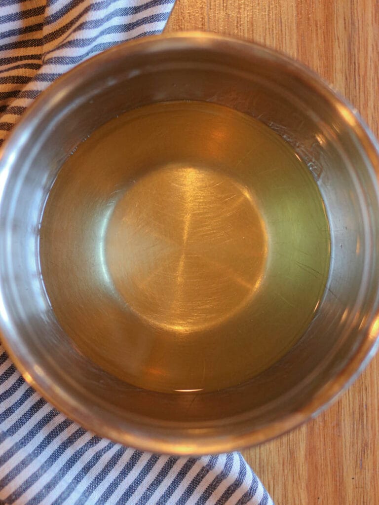 Melted tallow and fractionated coconut oil mixed in a metal bowl.