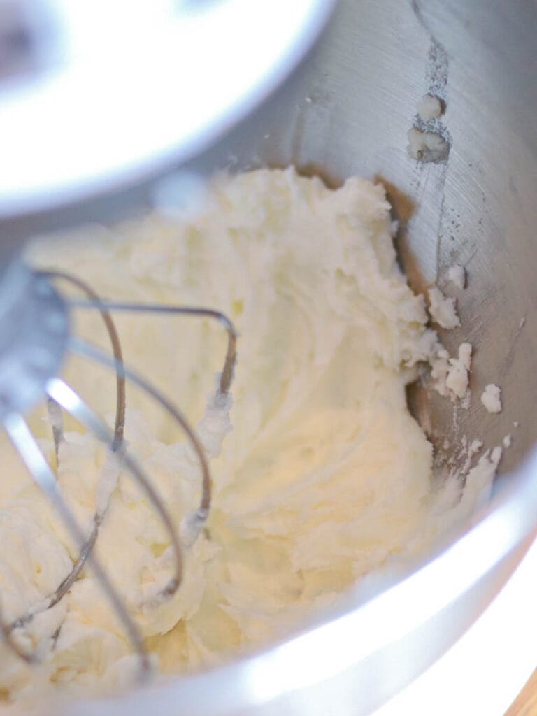 Light and fluffy white body butter being whipped in a stand mixer.