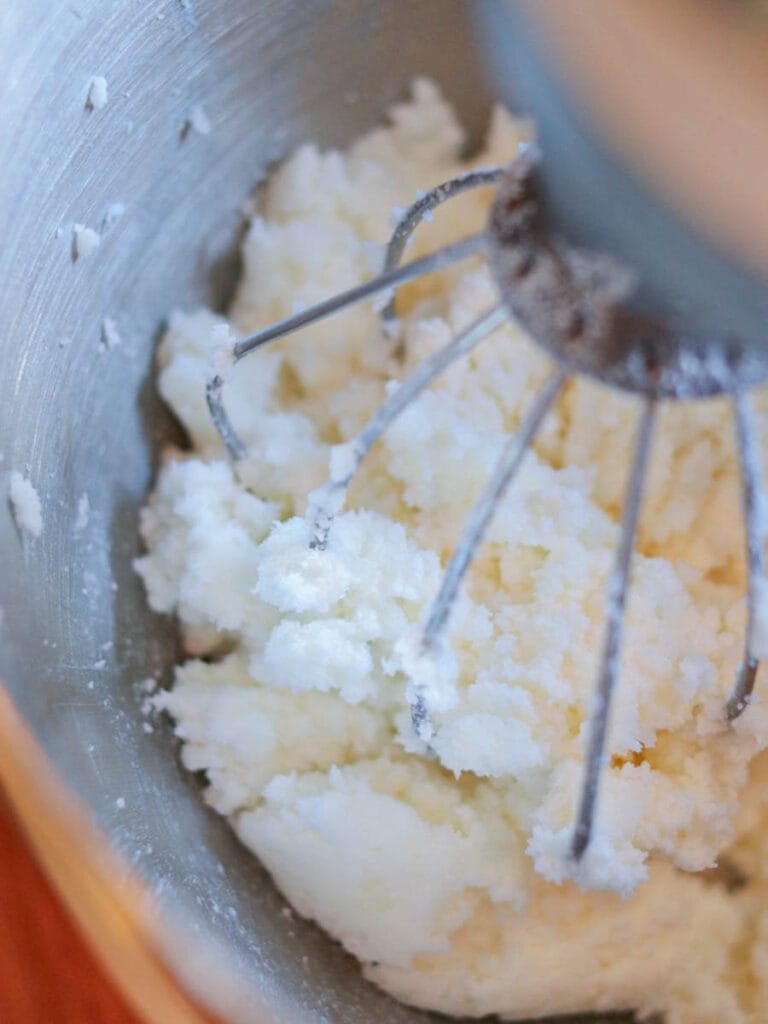 Using a stand mixer to mix sugar into body scrub.