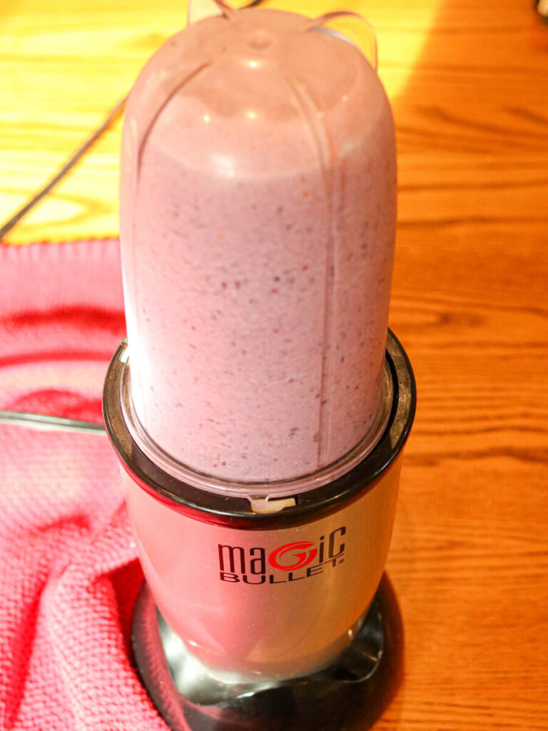 Blending a smoothie using a Magic Bullet blender.
