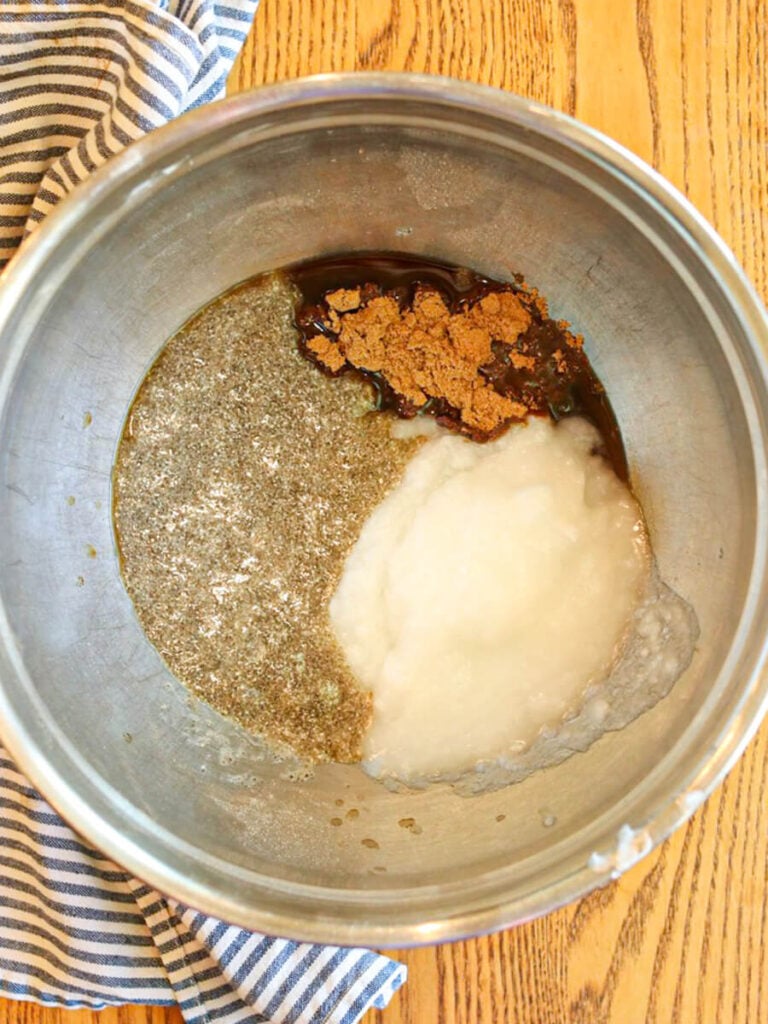 Wet ingredients including chia eggs, coconut oil, and coconut sugar in a mixing bowl.
