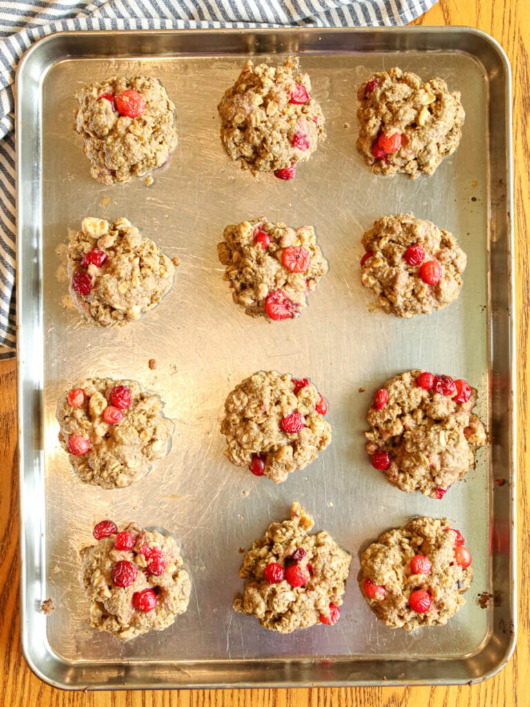 Cranberry walnut oatmeal cookies on a cookie sheet before baking.