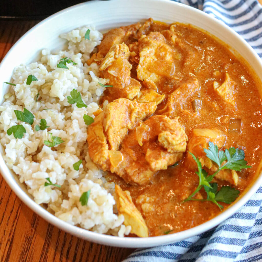 Close up of Indian chicken curry in a bowl with rice.