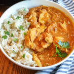 Close up of Indian chicken curry in a bowl with rice.