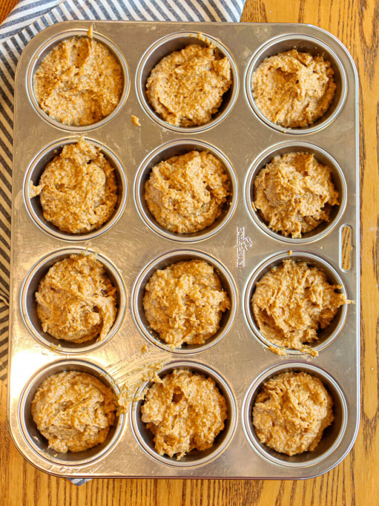 Banana pumpkin muffin batter in a muffin pan ready for baking.