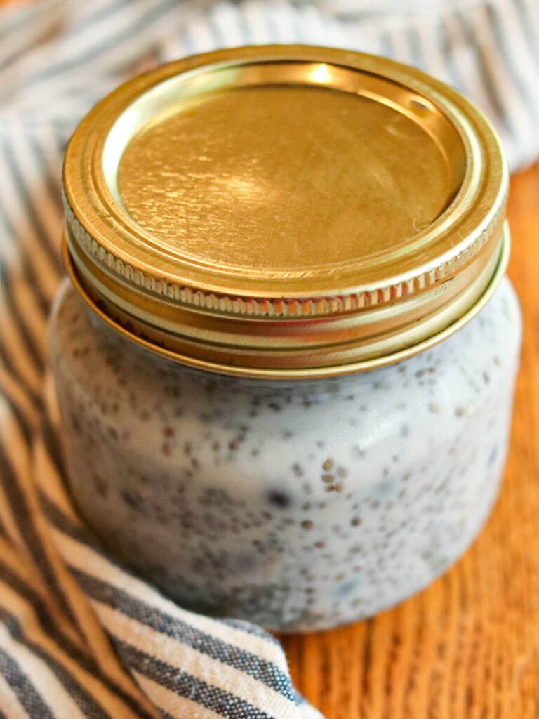 Blueberry chia seed pudding in a small jar with the lid on.