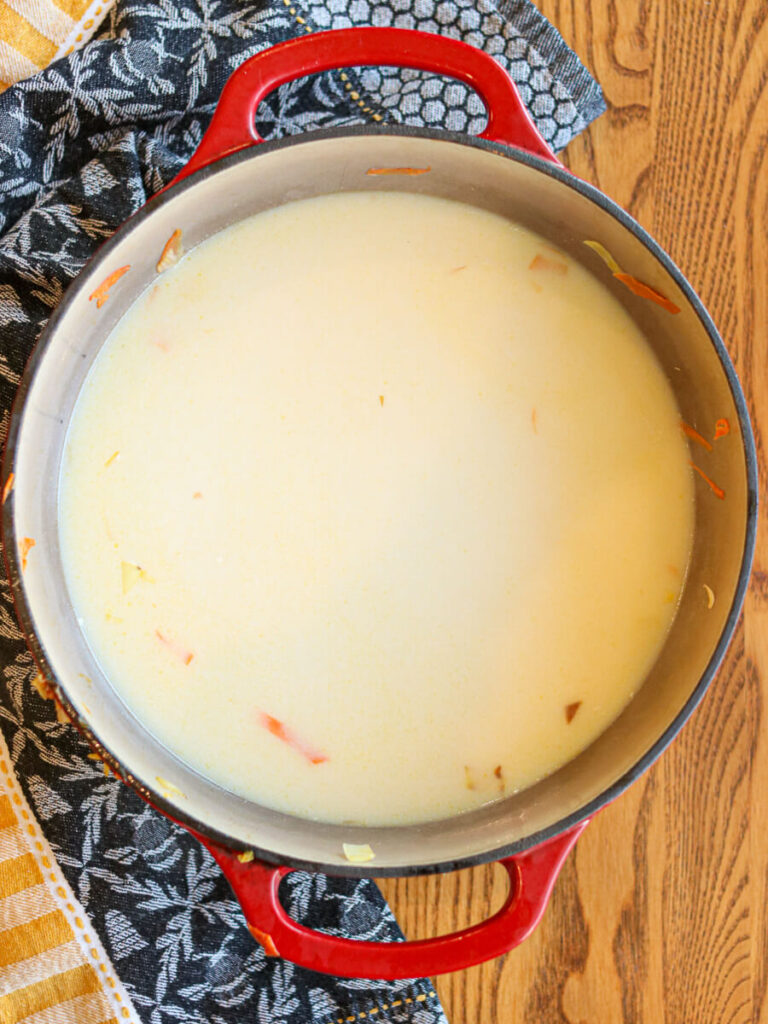Broth and half-and-half warming in a dutch oven.
